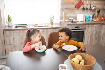 Multiracial family enjoys breakfast together in cozy kitchen settingの写真素材