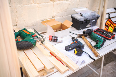 Screwdriver and wooden plank on a table outdoorsの写真素材