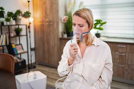 Woman using a nebulizer for respiratory treatment in a cozy indoor setting