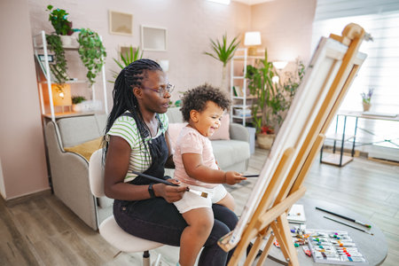 Happy indoor painting with mother and childの写真素材