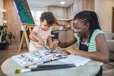 Creative bonding between a mother and child in a cozy studioの写真素材