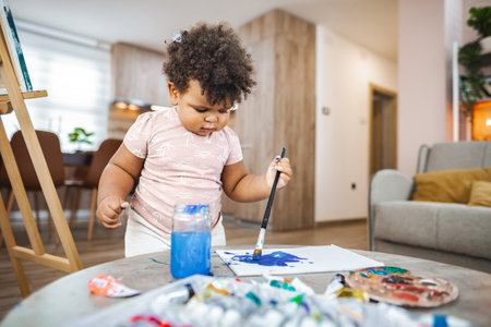 Young artist creating in afternoon light at homeの写真素材