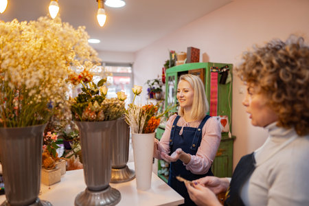 Creating beautiful floral arrangements in a vibrant flower shop in the heart of the cityの写真素材