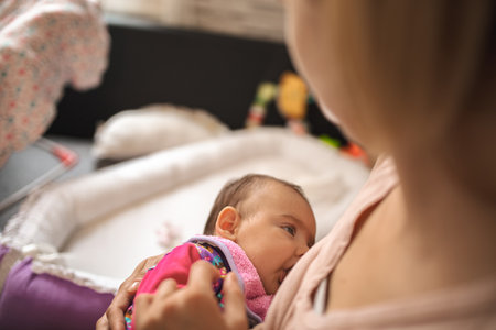 Mother nursing baby in a cozy daytime setting