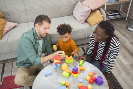 Multiracial family playing with colorful blocks in their living room