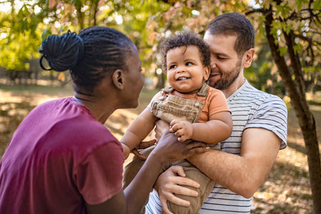 Family joy captured in a sunlit park during autumn momentsの写真素材