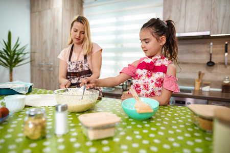 Joyful moments in the kitchen as mother and daughter bake together