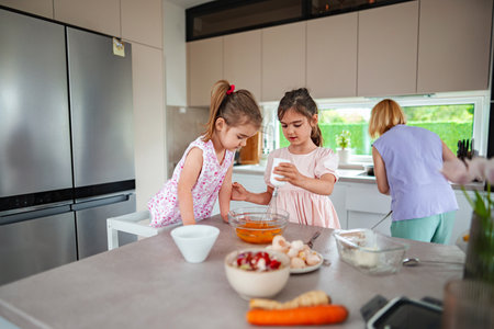 Baking fun with kids in a sunny kitchen afternoonの写真素材