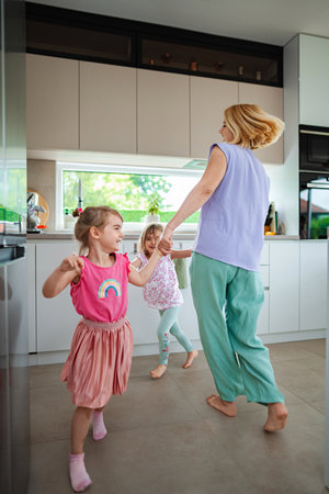 Joyful moments of dancing in the modern kitchenの写真素材