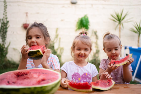 Joyful moments of children savoring watermelon in summer delight