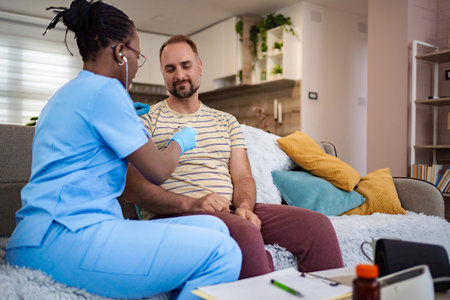 Caregiver provides health support during home visitの写真素材