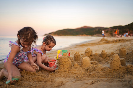 Sunset beach fun: building sandcastles with familyの写真素材