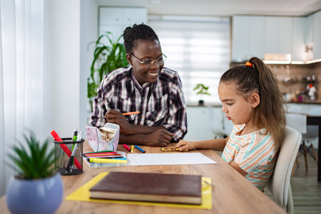 Creative learning moment between a mentor and child at homeの写真素材