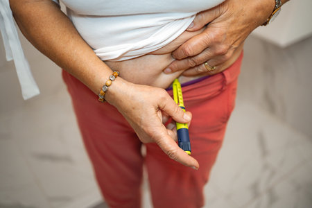 Person administering a medication injection in a home setting during daytime