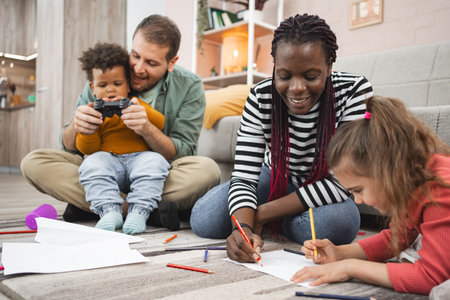 Multiracial family enjoys creative activities at homeの写真素材