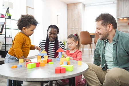 Multiracial family playing with colorful building blocks at home