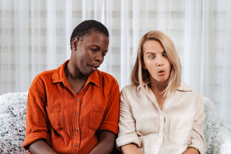 Two female friends are making funny faces and pulling silly expressions