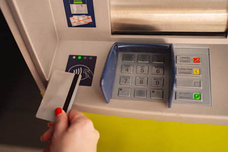 Individual using contactless card at automated cash machine