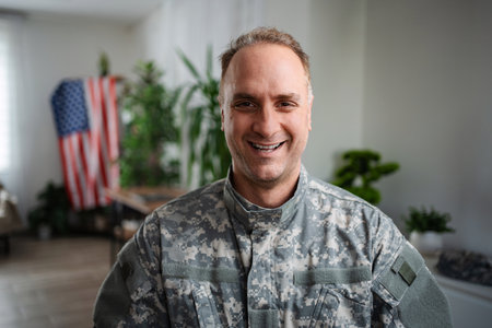 Portrait of smiling american veteran soldier in uniform looking at cameraの写真素材