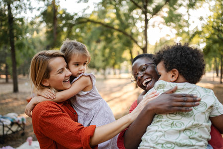 Mothers embracing their children in a parkの写真素材