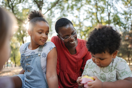 Mother and children playing in the parkの写真素材