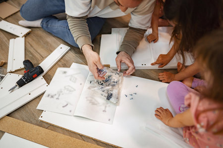 Family bonding while assembling furniture on a weekend afternoonの写真素材