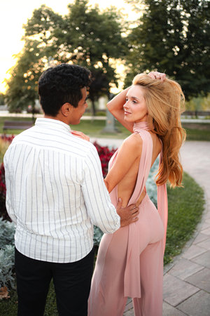 Couple enjoying a romantic moment in a beautiful park at sunsetの写真素材