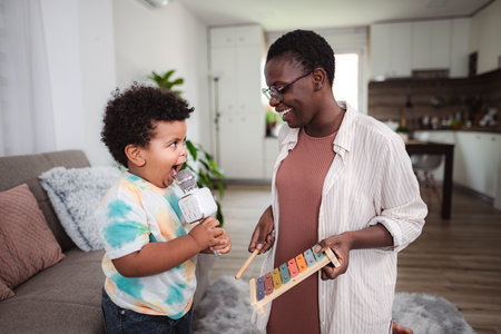 Mother and son playing music and singing at home