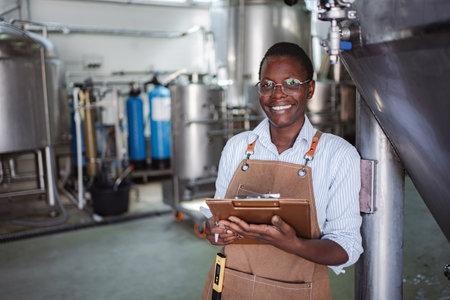 Woman worker inspecting quality control in modern breweryの写真素材