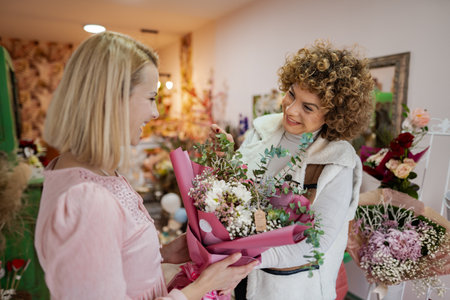 Joyful exchange of a beautiful bouquet in a charming flower shop