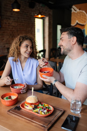 Young couple enjoying a meal together at a restaurantの写真素材