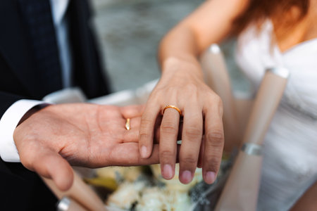 Diverse couple exchanging wedding rings on marriage dayの写真素材