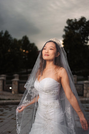 Chinese bride wearing white wedding dress on special dayの写真素材