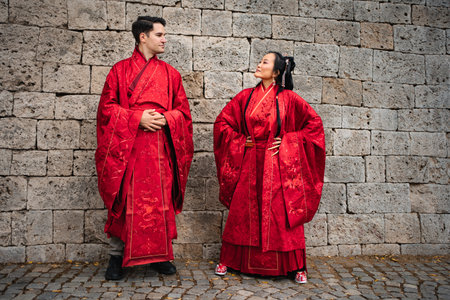 Interracial couple celebrating traditional Chinese wedding ceremonyの写真素材