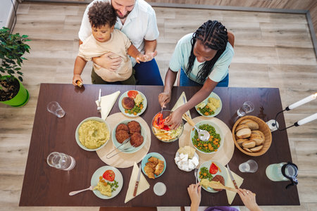 Family gathers around the table for homemade mealsの写真素材