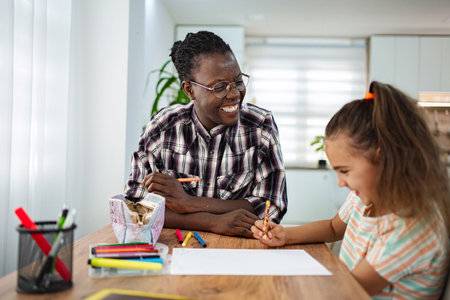 Creative bonding time with art between a child and adult indoorsの写真素材