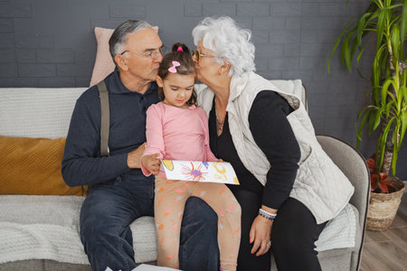 Grandparents sharing love and creativity indoorsの写真素材