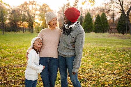 Diverse women and child enjoying autumn park walk