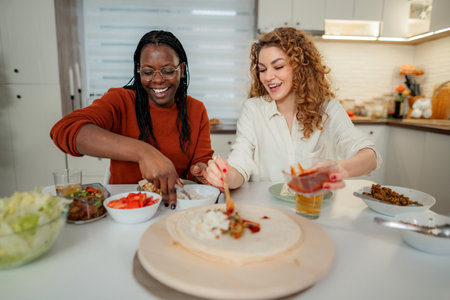 Diverse women friends preparing tasty tortillas for lunch