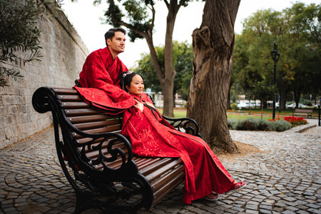 Mixed couple celebrating wedding day in traditional Chinese clothingの写真素材
