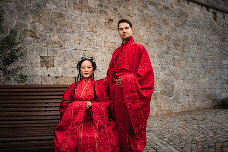 Diverse couple celebrating wedding in traditional Hanfu attireの写真素材