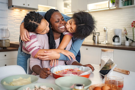 Loving family cooking pizza together in domestic kitchenの写真素材