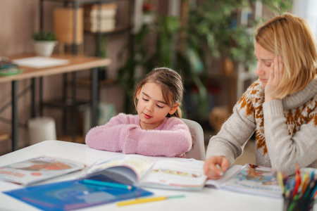 Tired mother and child struggling with homework at home