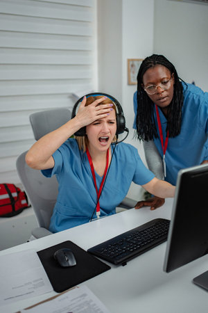 Healthcare team experiencing frustration and computer problem at officeの写真素材