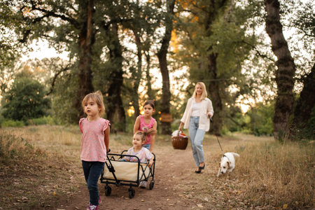 Family enjoying a walk in the woods with their dog pulling a wagon
