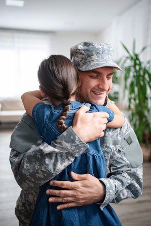 Soldier father is hugging his daughter at home