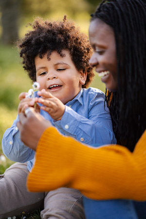 Mother and son bonding with flowers outdoors in nature