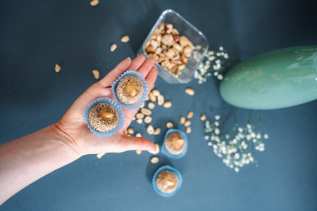 Hand holding homemade energy balls with peanuts