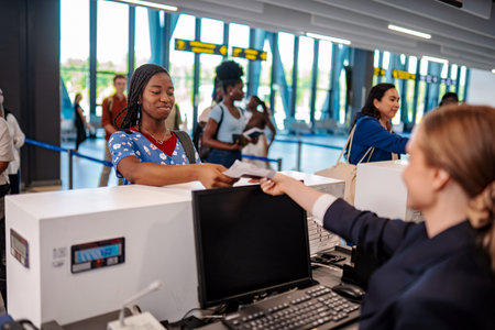 Traveler checking in airport with airline staff at counter