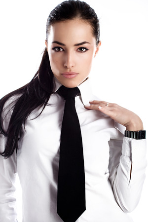 young businesswoman in white shirt with tie, studioの写真素材